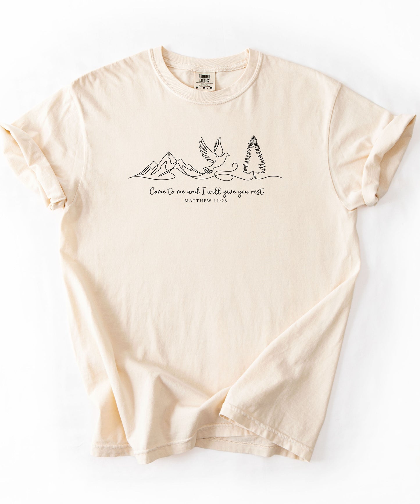 an ivory t-shirt with nature-themed design and text that says "come to me and i will give you rest matthew 11:28" 