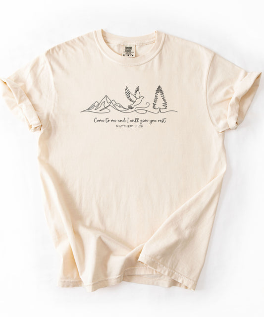 an ivory t-shirt with nature-themed design and text that says "come to me and i will give you rest matthew 11:28" 