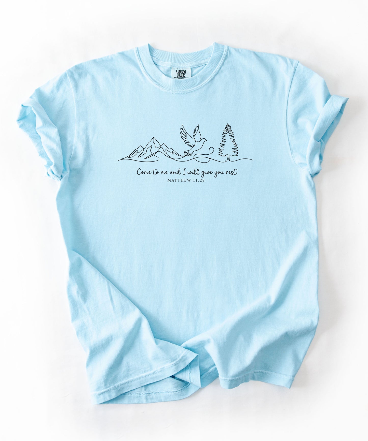 a chambray t-shirt with nature-themed design and text that says "come to me and i will give you rest matthew 11:28" 