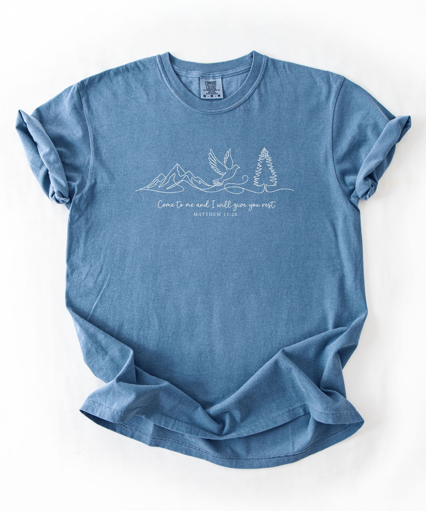 a blue jean t-shirt with nature-themed design and text that says "come to me and i will give you rest matthew 11:28" 