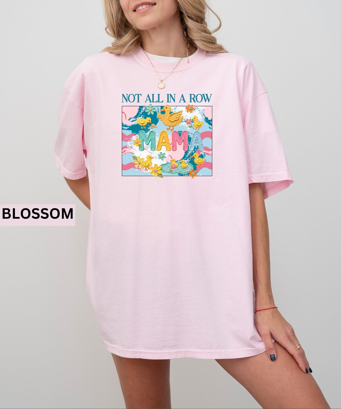light pink "mama" t-shirt with colorful graphic design featuring ducks and text on a white background.