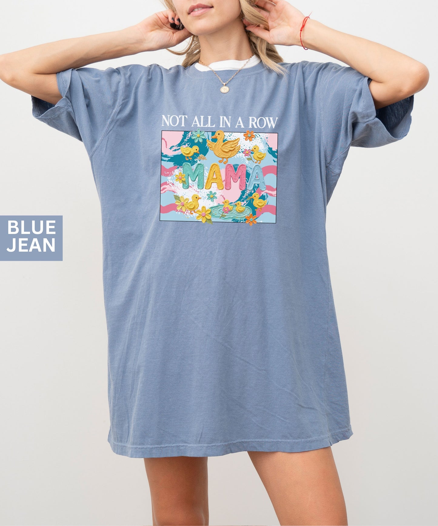 blue jean "mama" t-shirt with colorful graphic design featuring ducks and text on a white background.