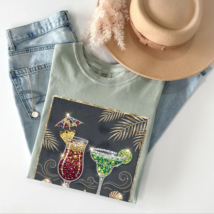 bay t-shirt with cocktail design, jeans, and hat on a white background