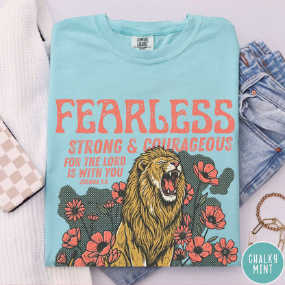 chalky mint t-shirt with a lion graphic and motivational text  fearless, strong and courageous on a pink background