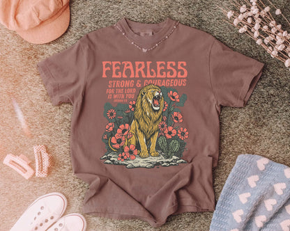 espresso t-shirt with a lion graphic and 'Fearless Strong Courageous' text on a textured surface.