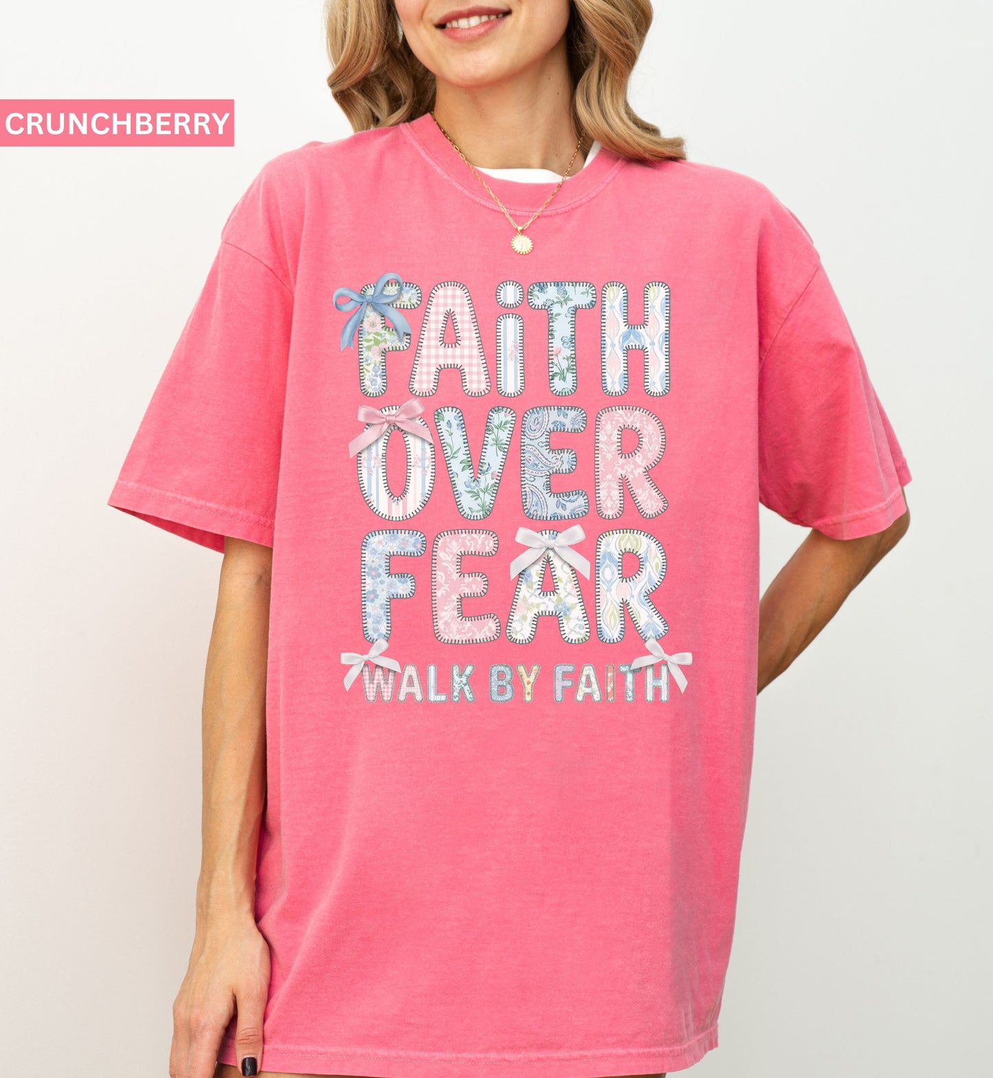 Person wearing a crunchberry t-shirt with 'Faith Over Fear' text on a plain background