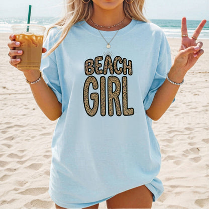 Person wearing a chambray color  'Beach Girl' shirt on a beach