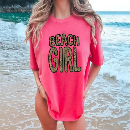 Person wearing a watermelon 'Beach Girl' shirt at the beach