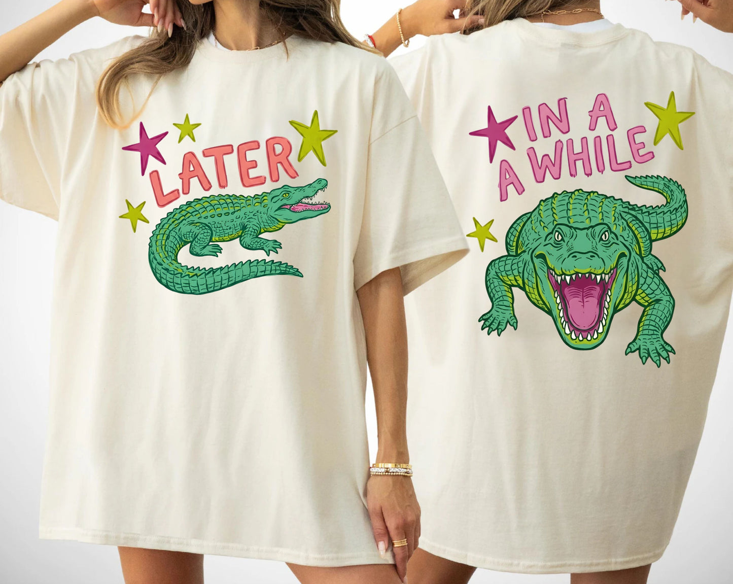 Two people wearing t-shirts with alligator graphics on front "later gator" and the text on back i"n a while crocodile"a plain background