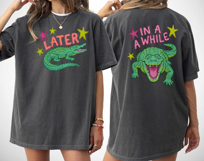 pepper t-shirts with alligator graphics on front "later gator" and the text on back i"n a while crocodile"a plain background