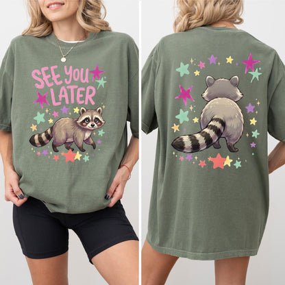 moss t-shirt with raccoon graphic and 'See You Later' text on the front with cute raccoon and cute raccoon on back of shirt on a white background