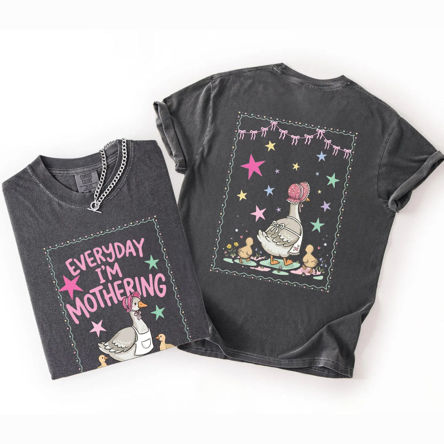 Two pepper t-shirts with front and back graphic designs of a mother goose her ducklings with phrase "everyday im mothering" and text on a white background