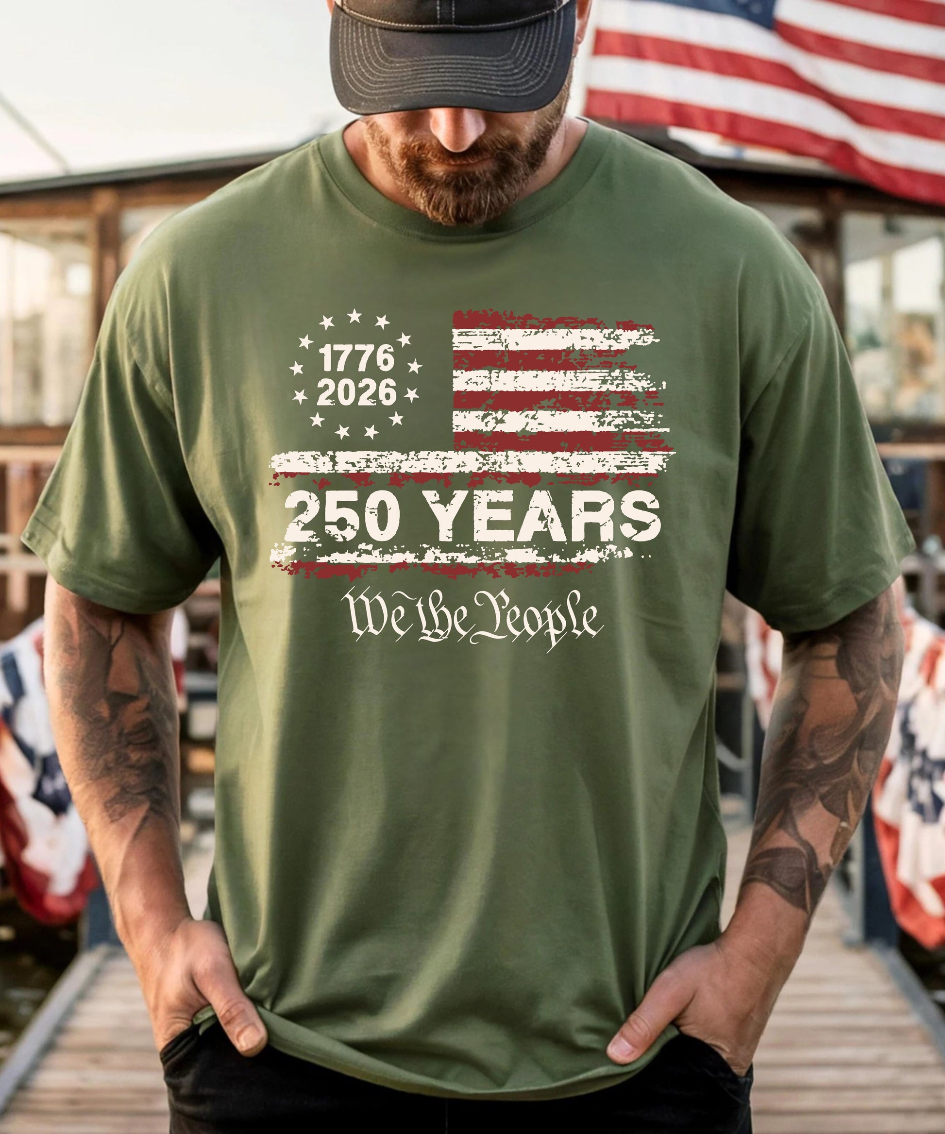 Person wearing a moss t-shirt with a 250th anniversary design in front of an American flag.