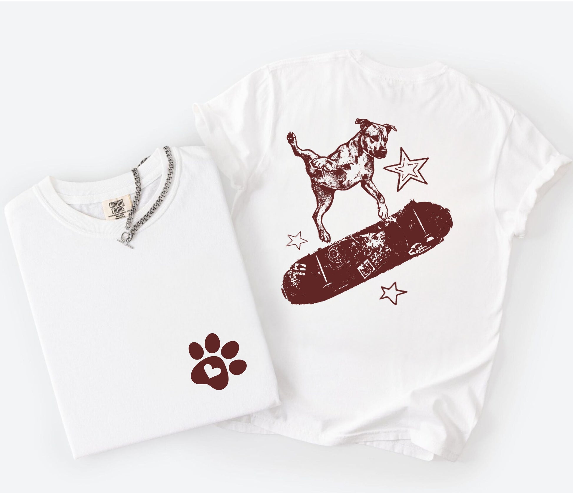 White sweatshirt with a dog on a skateboard graphic and paw print on a white background