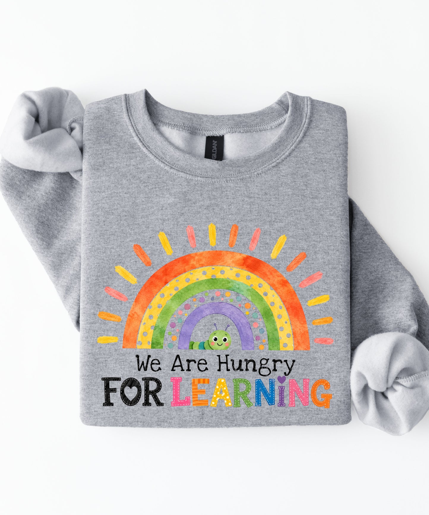 a sports gray sweatshirt with a rainbow and text that says we are hungry for learning design.