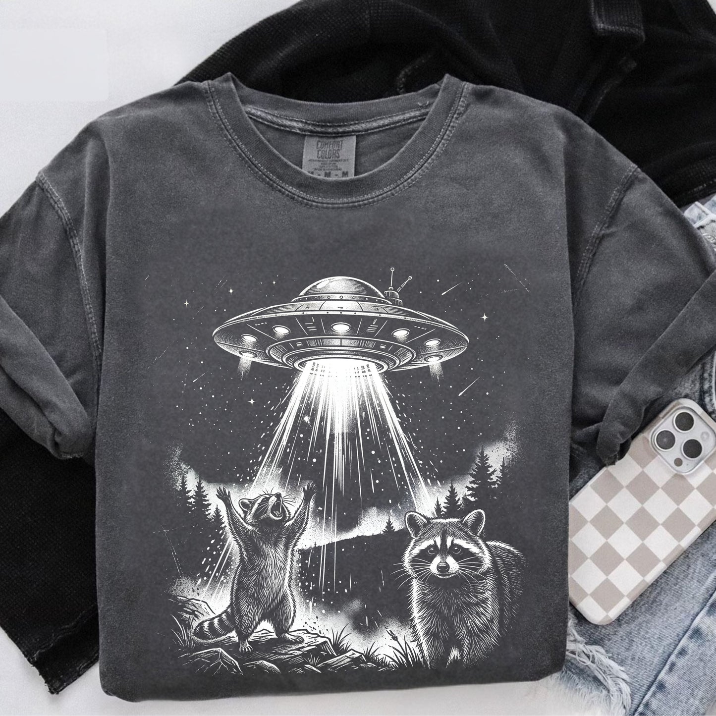 pepper sweatshirt with UFO and raccoon design on a white background