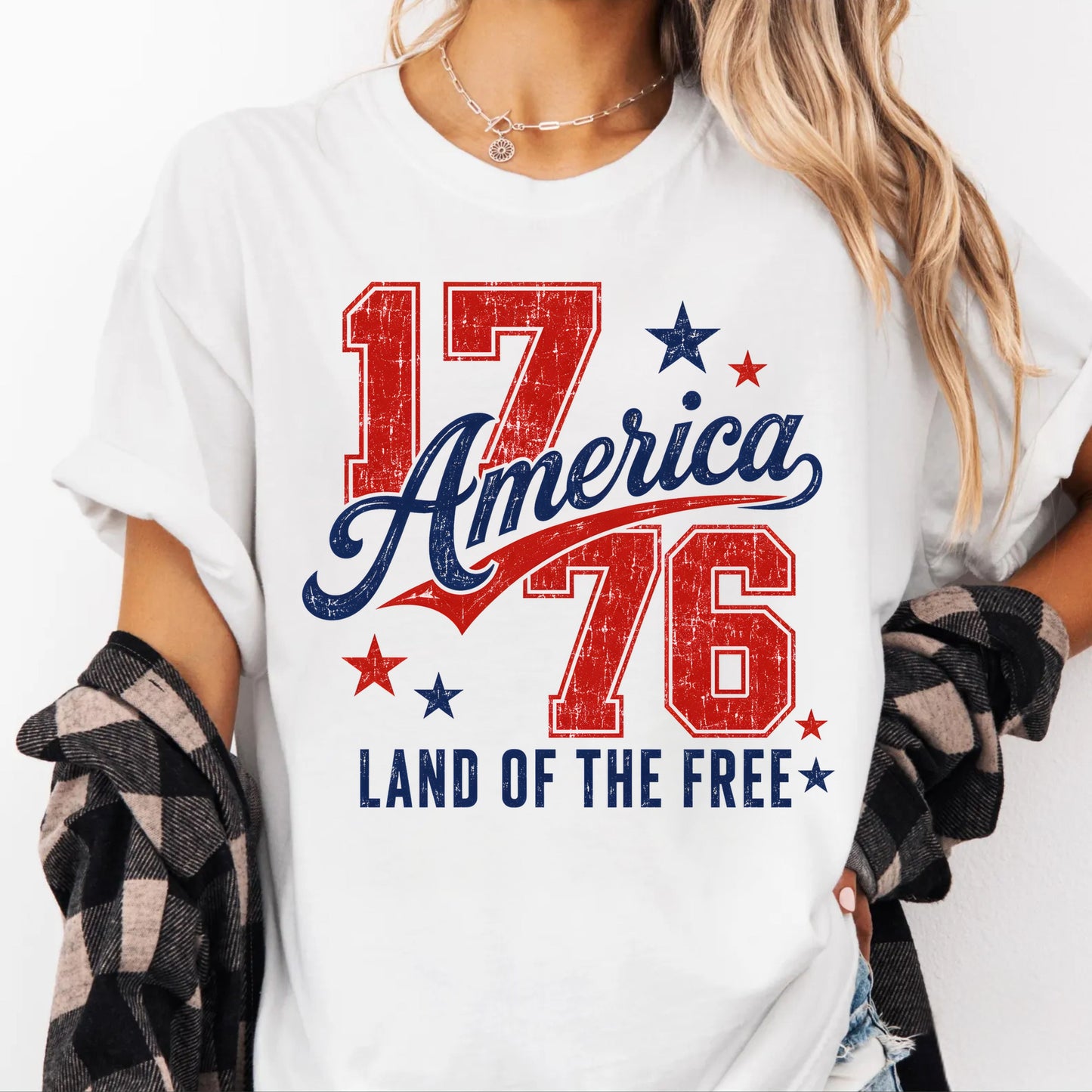 White t-shirt with '17 America 76 Land of the Free' design worn by a person.
