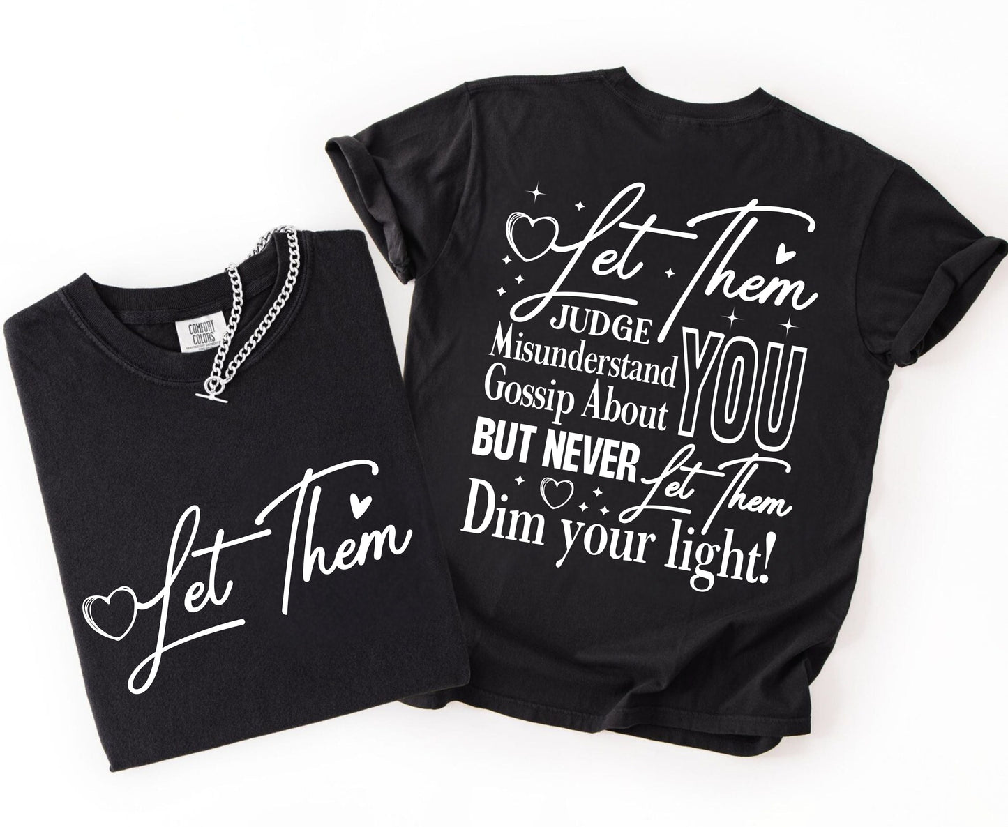 Two black t-shirts with inspirational text on a white background