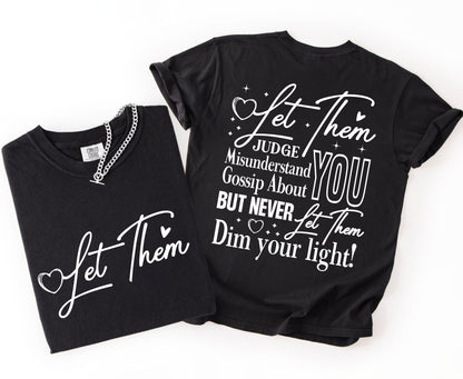 Two black t-shirts with inspirational text on a white background