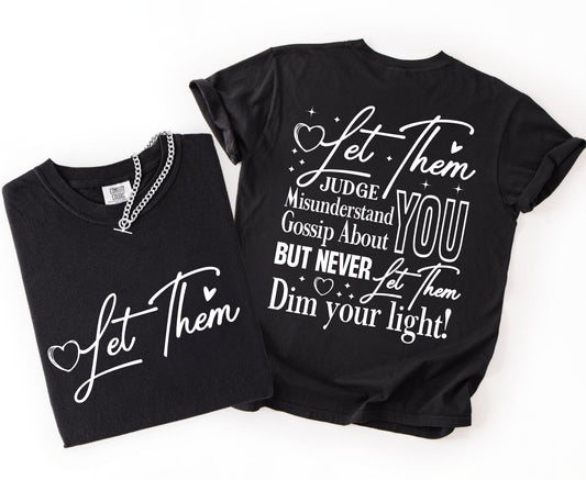 Two black t-shirts with inspirational text on a white background