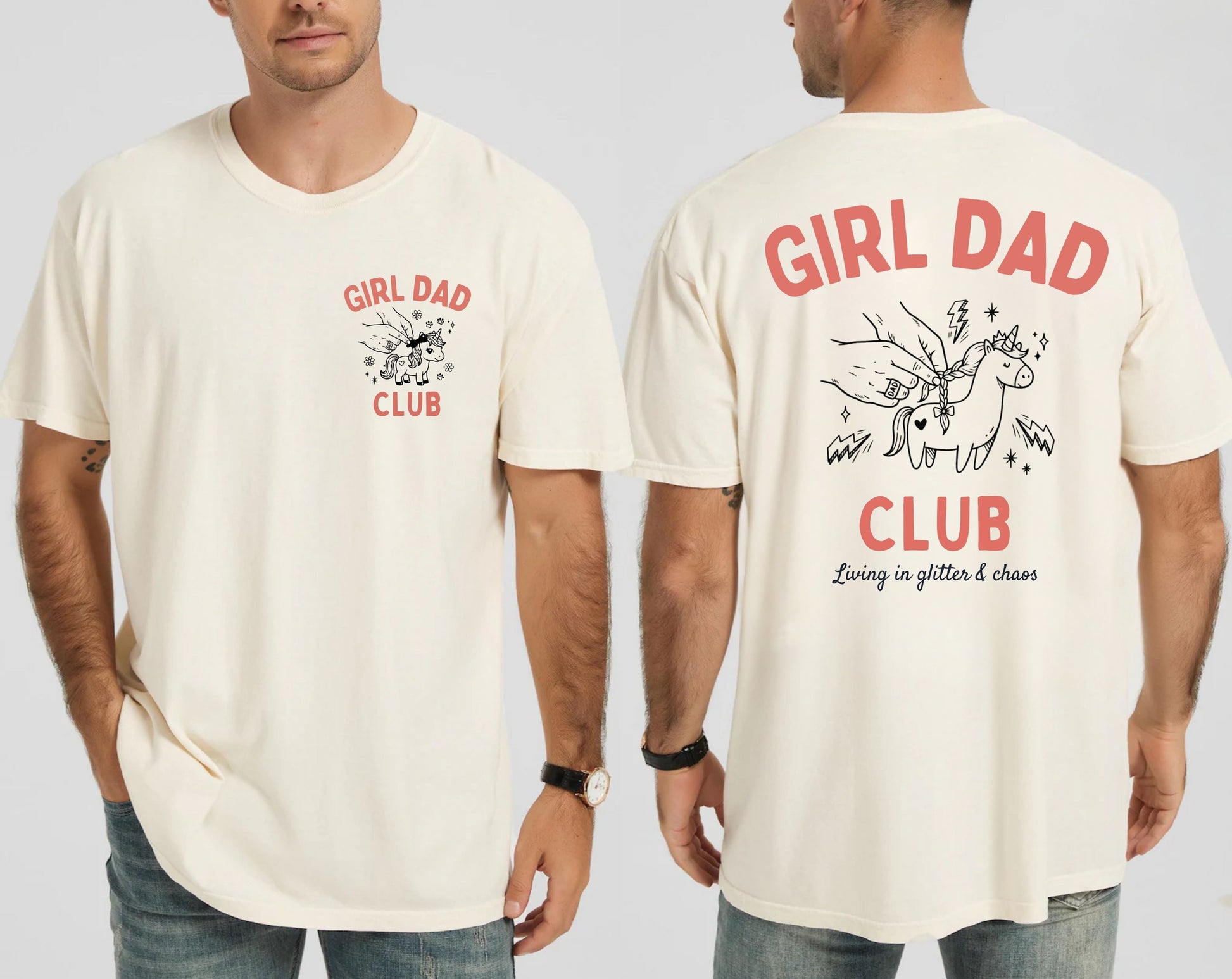 Man wearing an ivory t-shirt with 'Girl Dad Club' text and graphics on a plain background