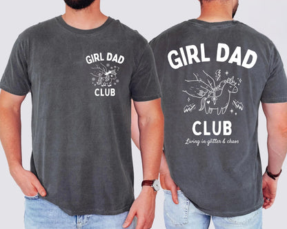 Two people wearing pepper colored t-shirts with 'Girl Dad Club' text and graphics on a plain background