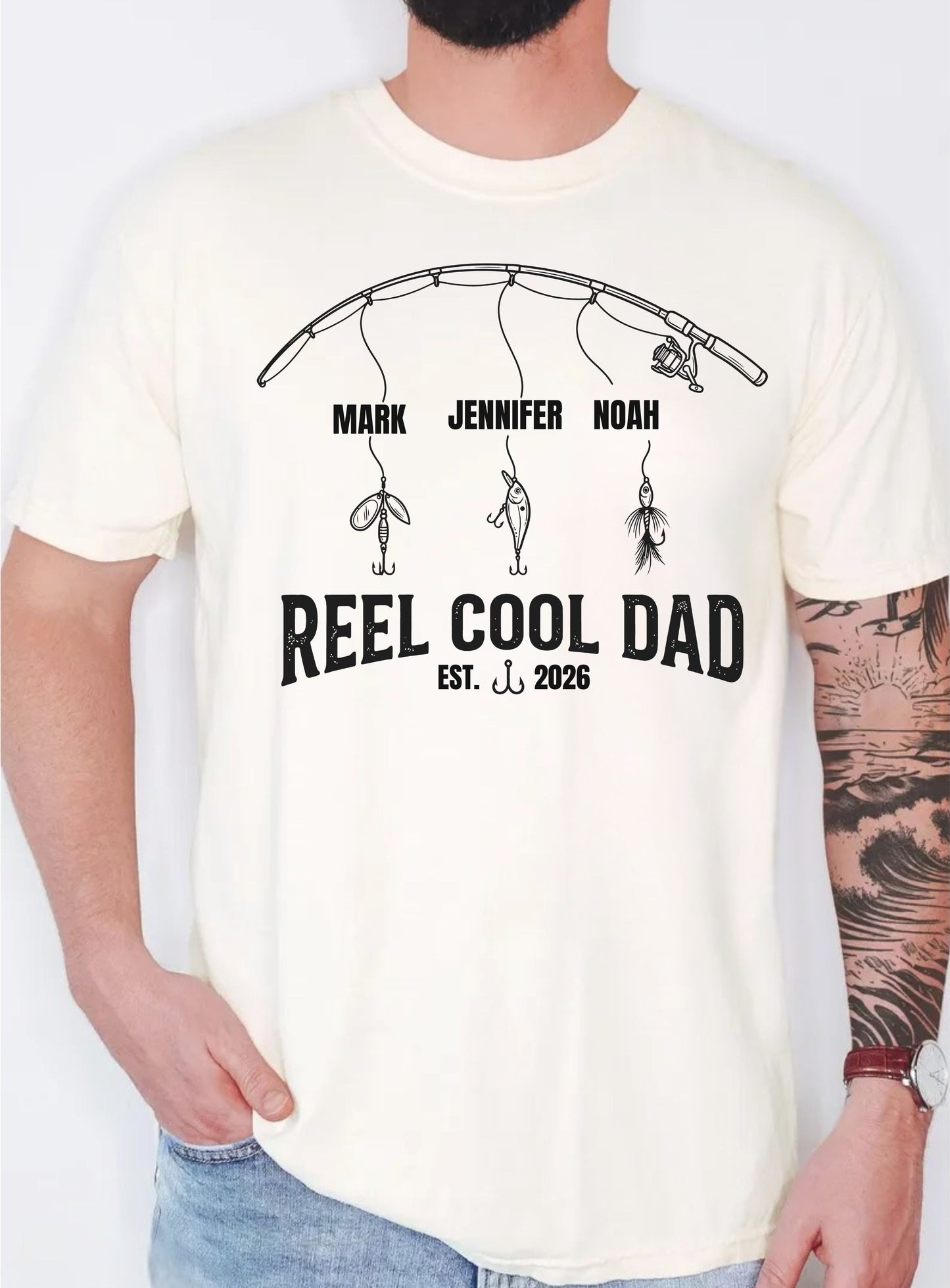 ivory  t-shirt with 'Reel Cool Dad' design and names on a plain background