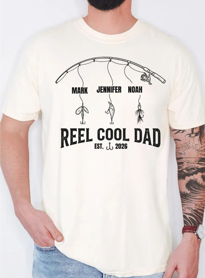 ivory  t-shirt with 'Reel Cool Dad' design and names on a plain background