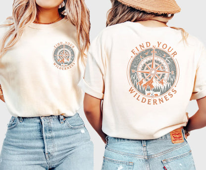 Two people wearing Ivory colored t-shirts with 'Find Your Wilderness' design on a plain background