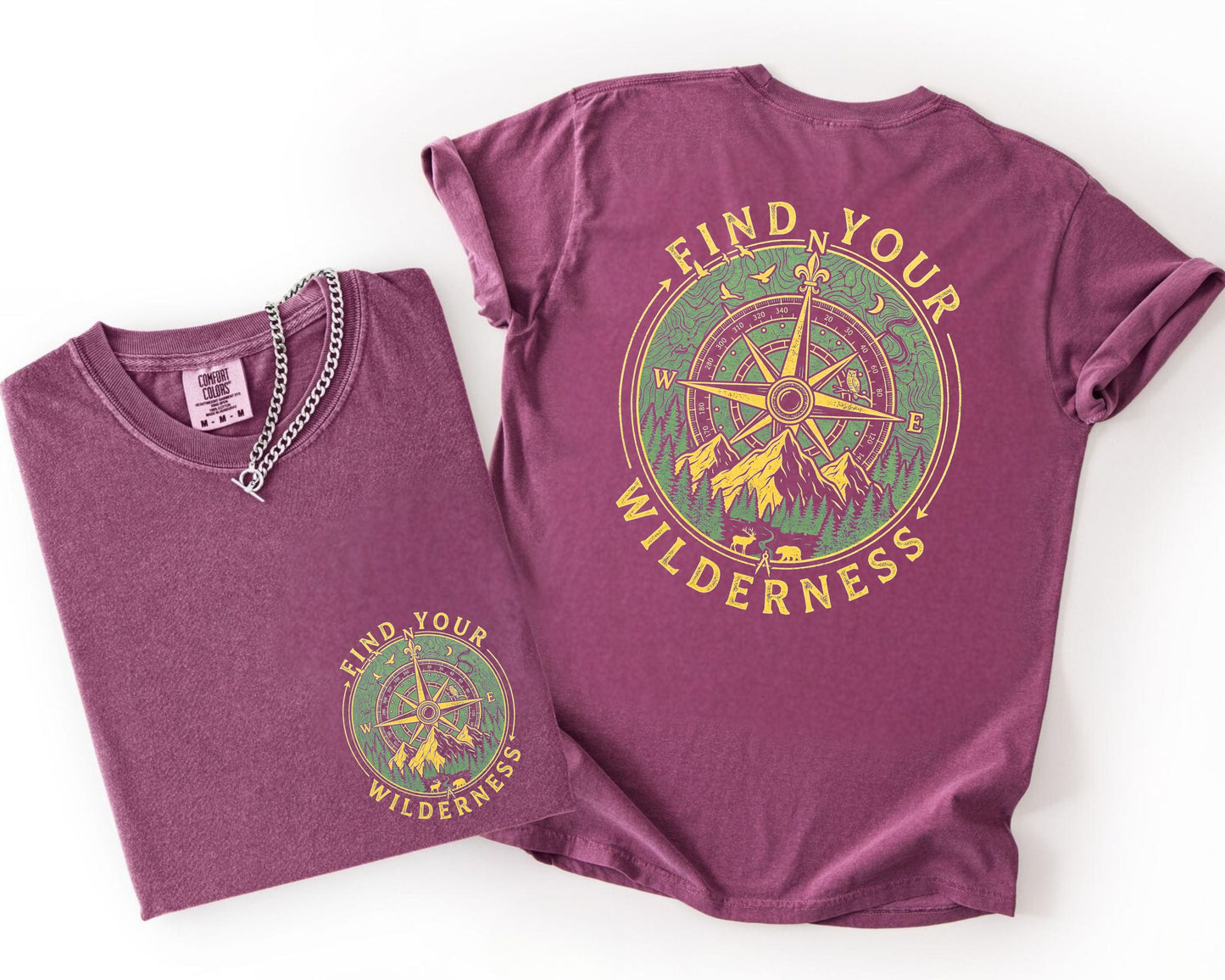 Two Berry colored  t-shirts with a compass design and 'Find Your Wilderness' text on a white background.