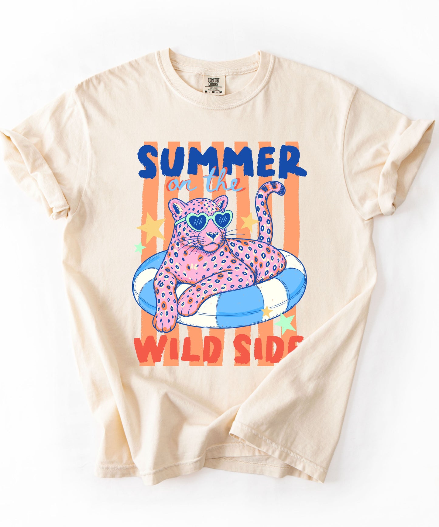 Ivory colored  t-shirt with a graphic of a leopard on an inflatable ring and 'Summer on the Wild Side' text.