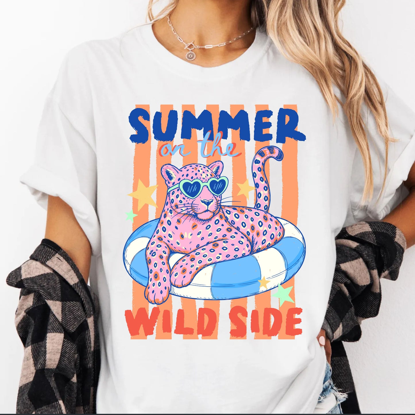 White t-shirt with a colorful graphic of a panther on an inner tube and text 'Summer on the Wild Side' worn by a person.