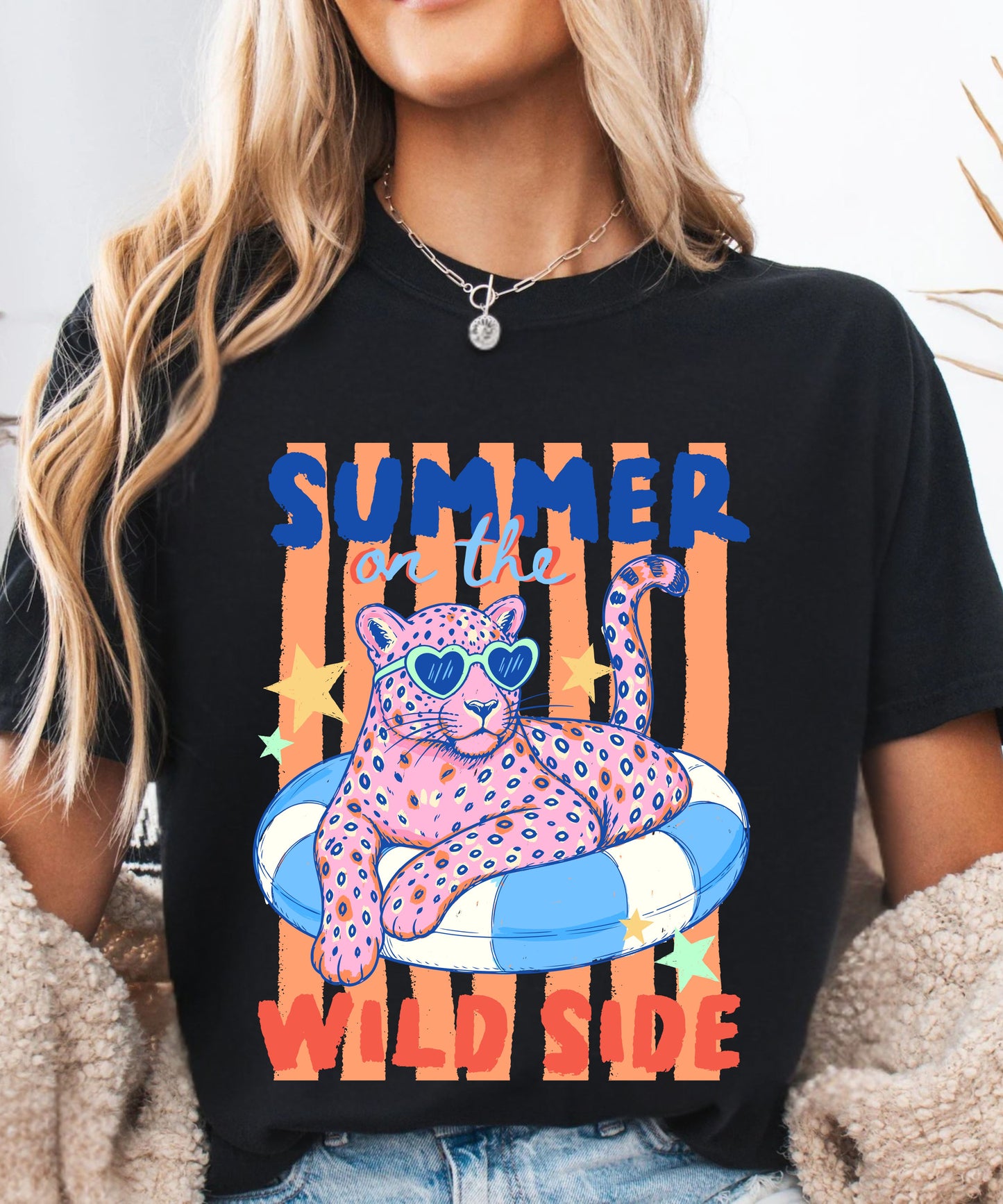 Person wearing a black t-shirt with a colorful graphic of a panther and text 'Summer on the Wild Side'.