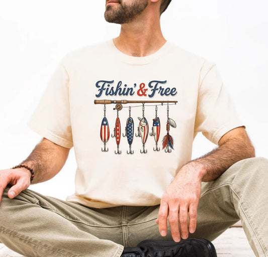 Man wearing an ivory t-shirt with 'Fishin' & Free' graphic design.