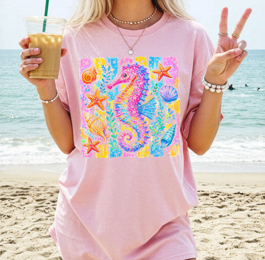 Seahorse Beach Art T-Shirt in Blossom — watercolor seahorse with shells and starfish graphic, garment-dyed comfort colors tee
