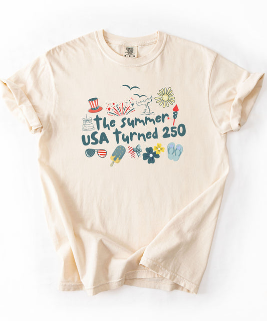 Ivory t-shirt with 'The summer USA turned 250' design on a white background