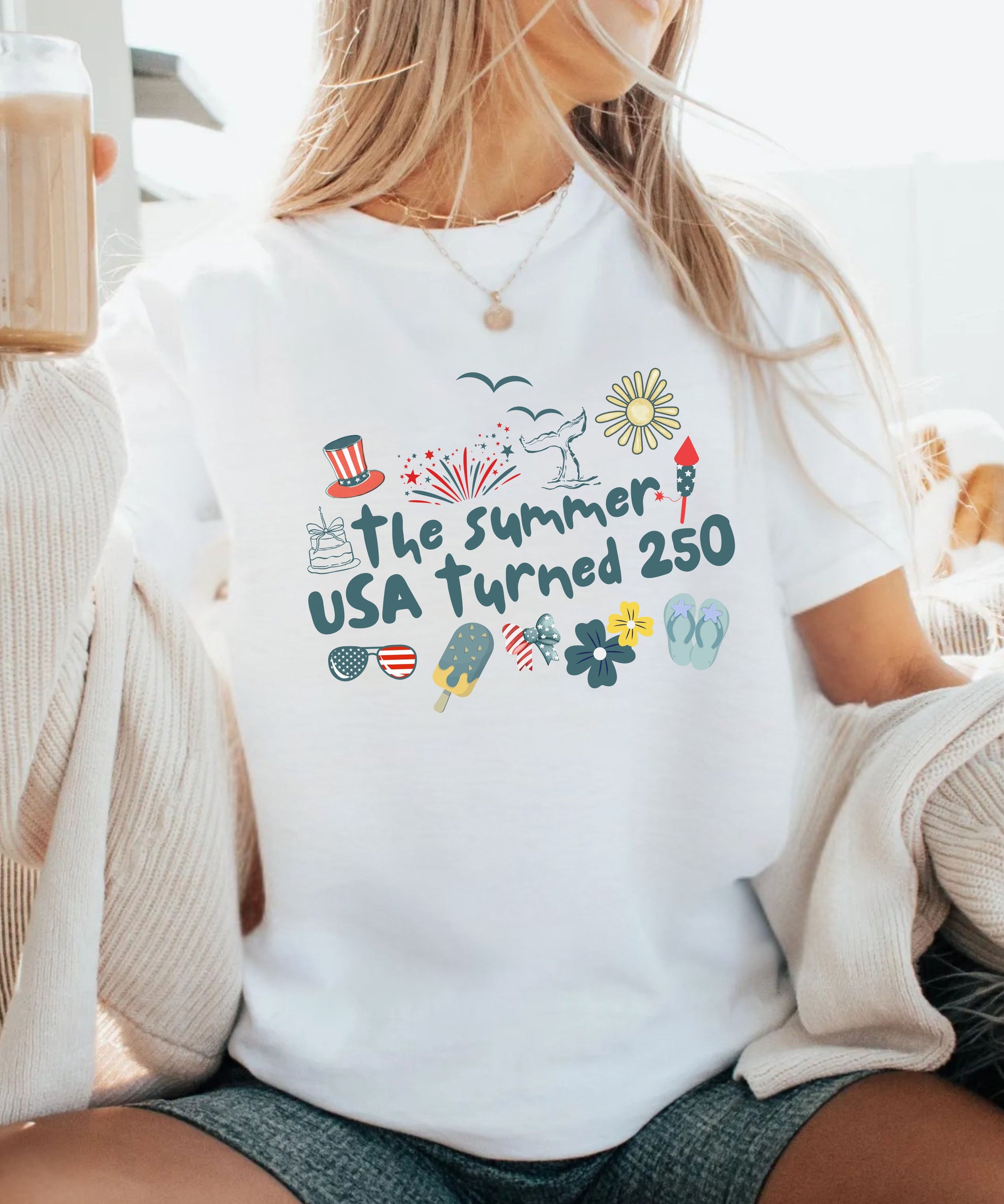 Person wearing a white t-shirt with 'The Summer USA Turned 250' text and graphics.