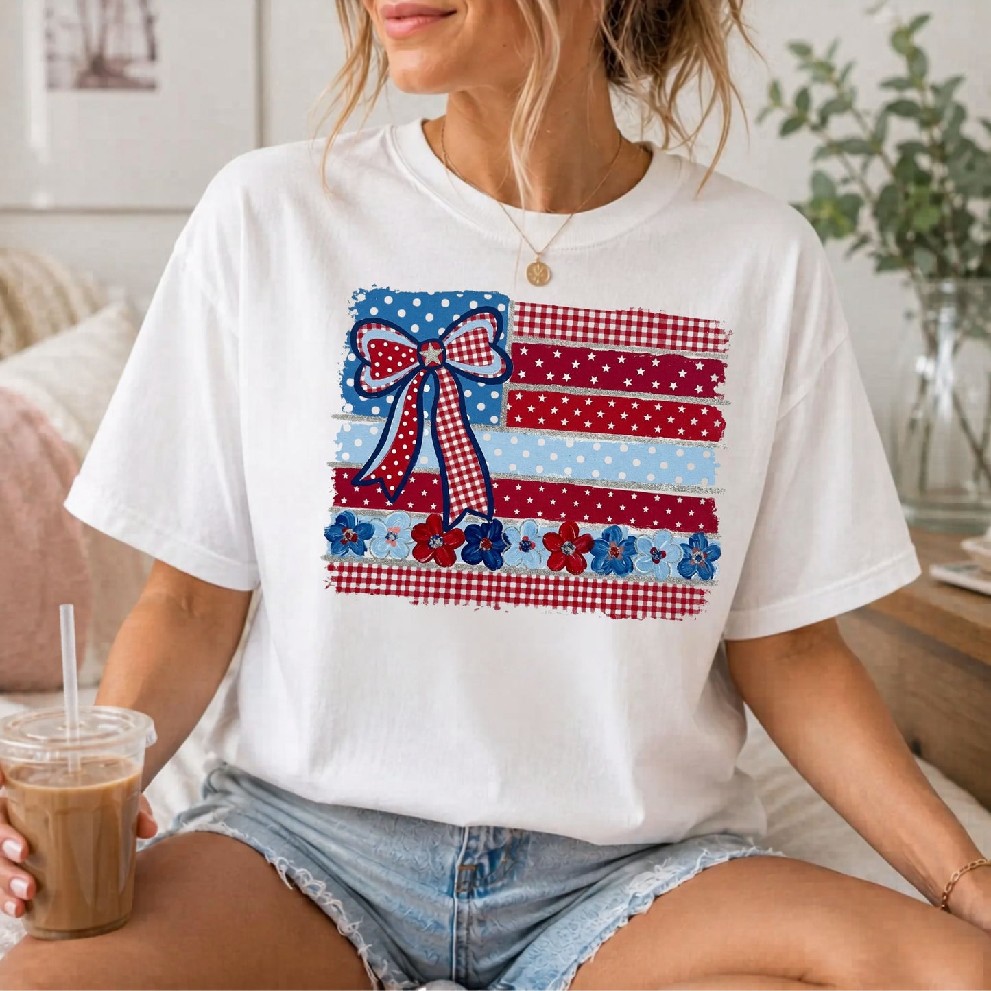 White garment-dyed t-shirt with Americana patchwork flag bow graphic in red, white and blue