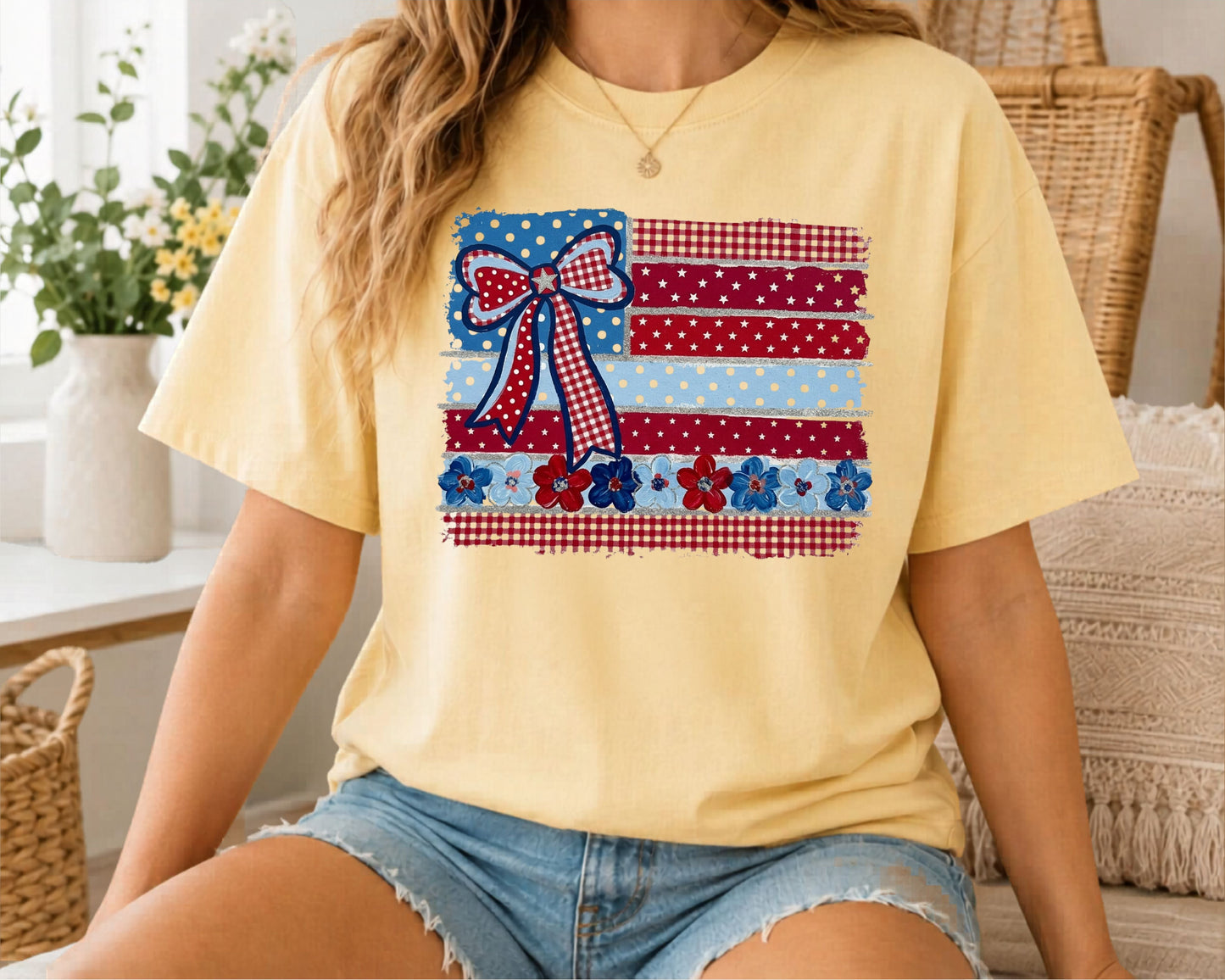 Butter garment-dyed t-shirt with Americana patchwork flag bow graphic in red, white and blue