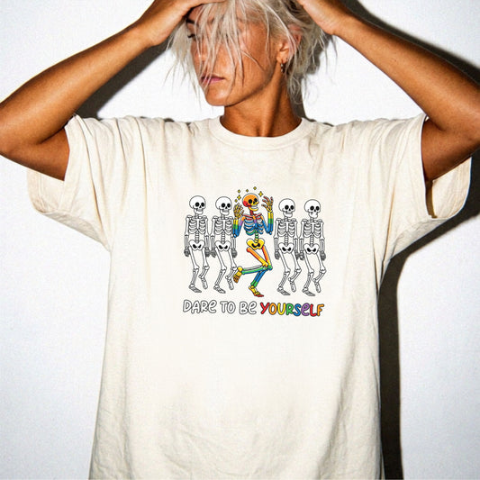 Dare to Be Yourself Rainbow Skeleton T-Shirt in Ivory — garment-dyed Halloween Pride tee