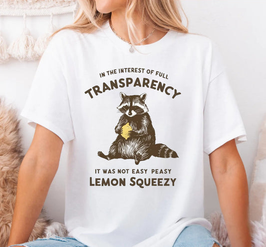 Funny raccoon sarcastic meme t-shirt in White — "Was Not Easy Peasy Lemon Squeezy" graphic tee