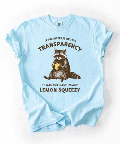 Funny raccoon sarcastic meme t-shirt in Chambray— "Was Not Easy Peasy Lemon Squeezy" graphic tee
