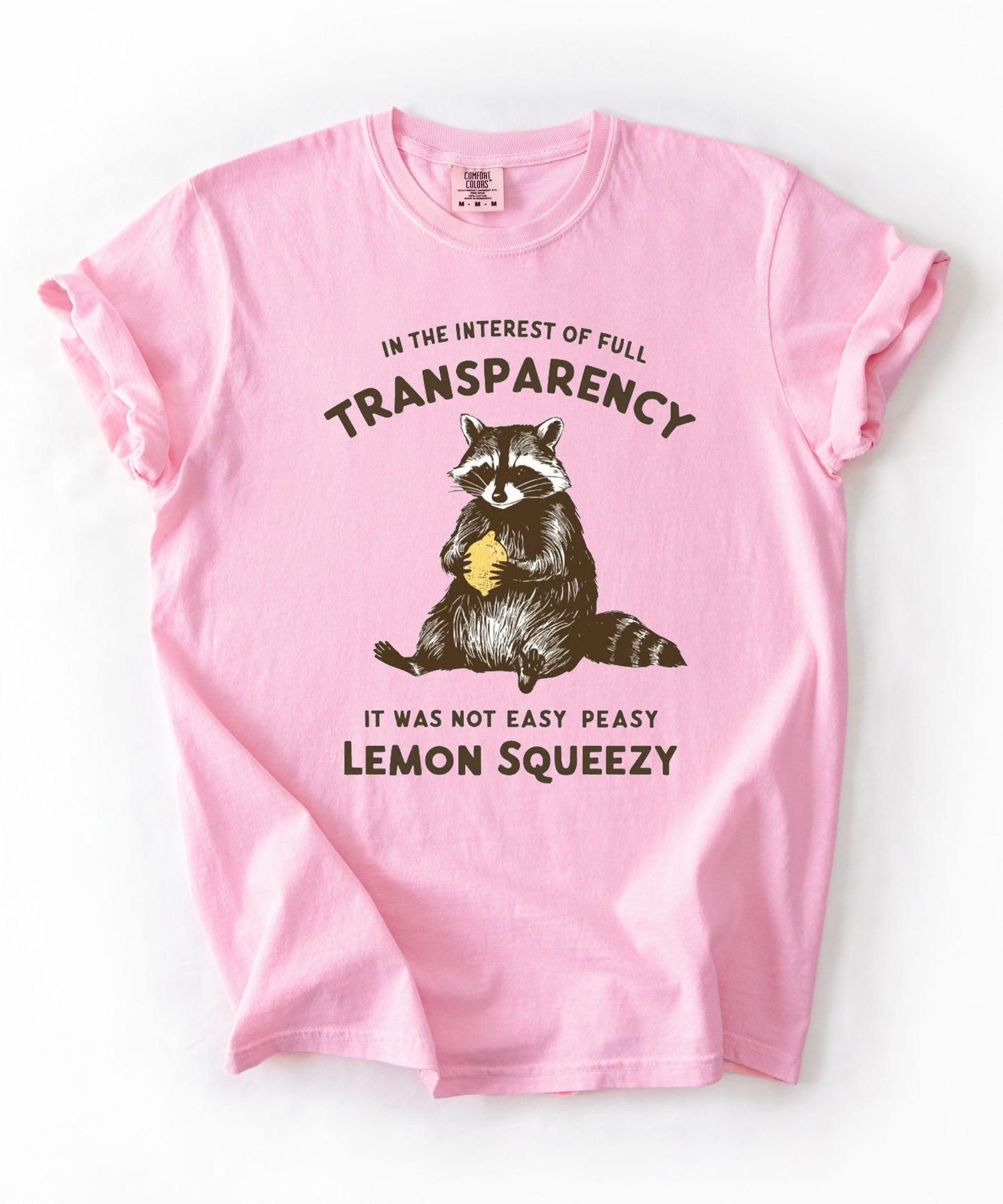 Funny raccoon sarcastic meme t-shirt in Blossom — "Was Not Easy Peasy Lemon Squeezy" graphic tee