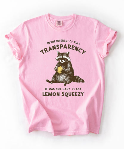Funny raccoon sarcastic meme t-shirt in Blossom — "Was Not Easy Peasy Lemon Squeezy" graphic tee