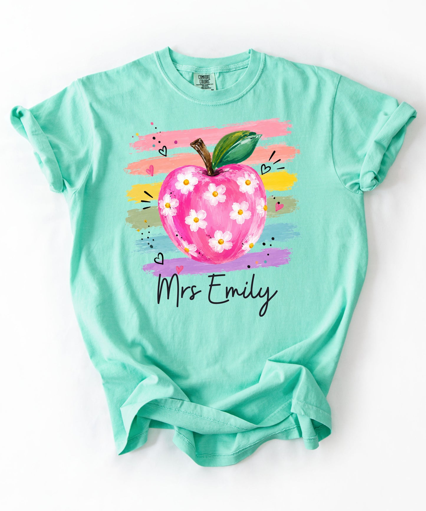 Personalized teacher t-shirt in Island Reef with floral apple graphic and colorful brushstroke stripes, custom name in script — garment-dyed cotton tee