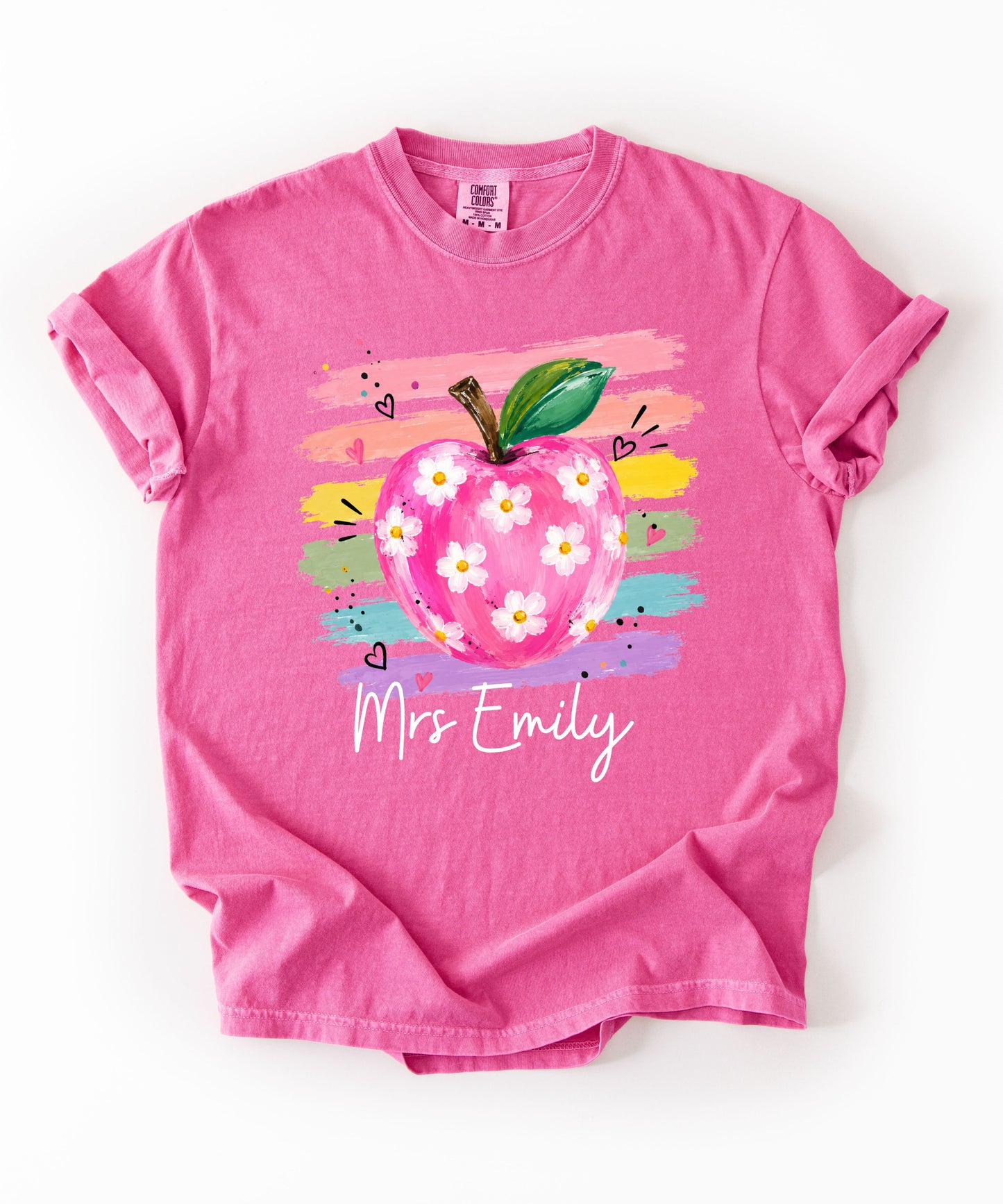Personalized teacher t-shirt in Crunchberry with floral apple graphic and colorful brushstroke stripes, custom name in script — garment-dyed cotton tee