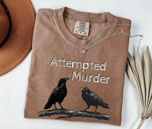 Espresso garment-dyed unisex crow graphic tee — Attempted Murder dark humor bird pun shirt