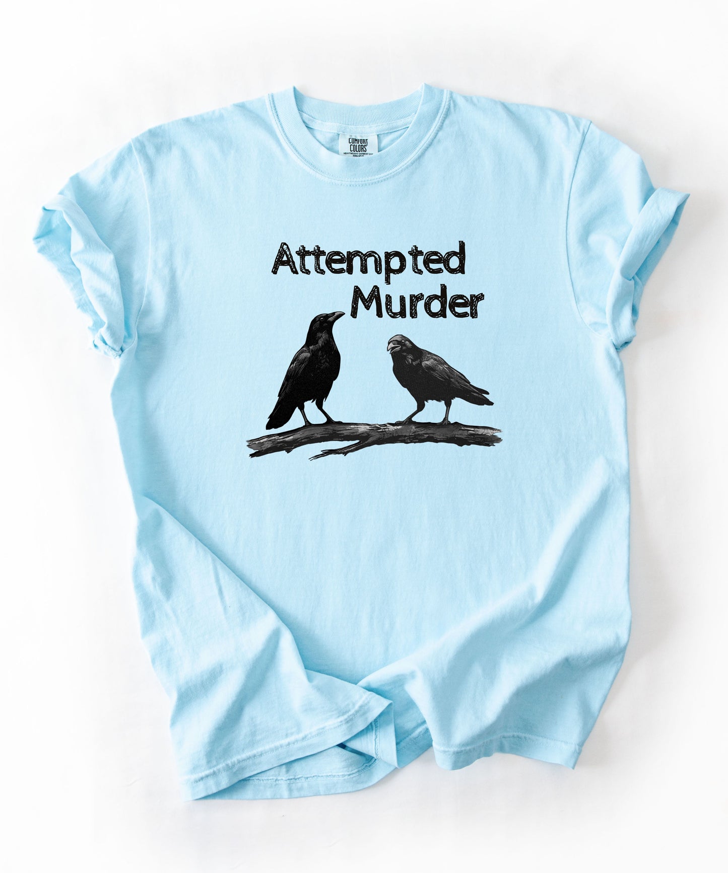 Chambray garment-dyed unisex crow graphic tee — Attempted Murder dark humor bird pun shirt