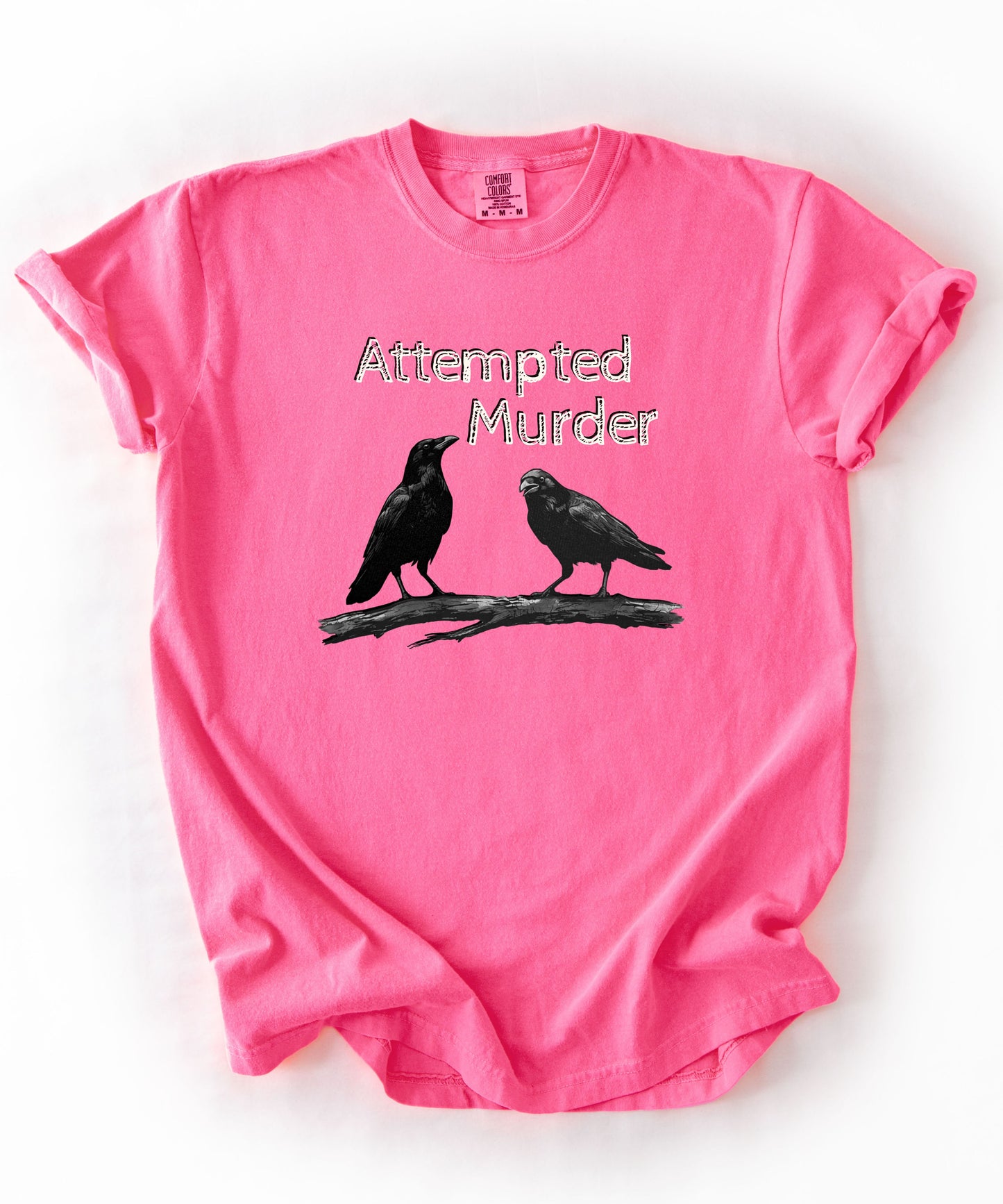 Neon Pink garment-dyed unisex crow graphic tee — Attempted Murder dark humor bird pun shirt