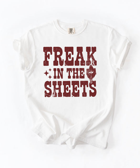 White Comfort Colors Freak in the Sheets funny Halloween ghost graphic tee — distressed western lettering with ghost and sparkle accents, flat lay